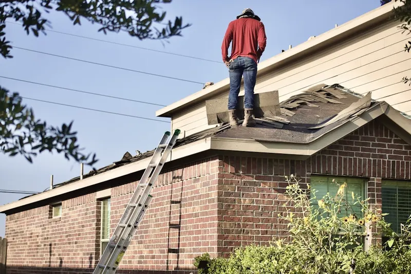 Professional roofer working on a residential roof in South Pocasset
